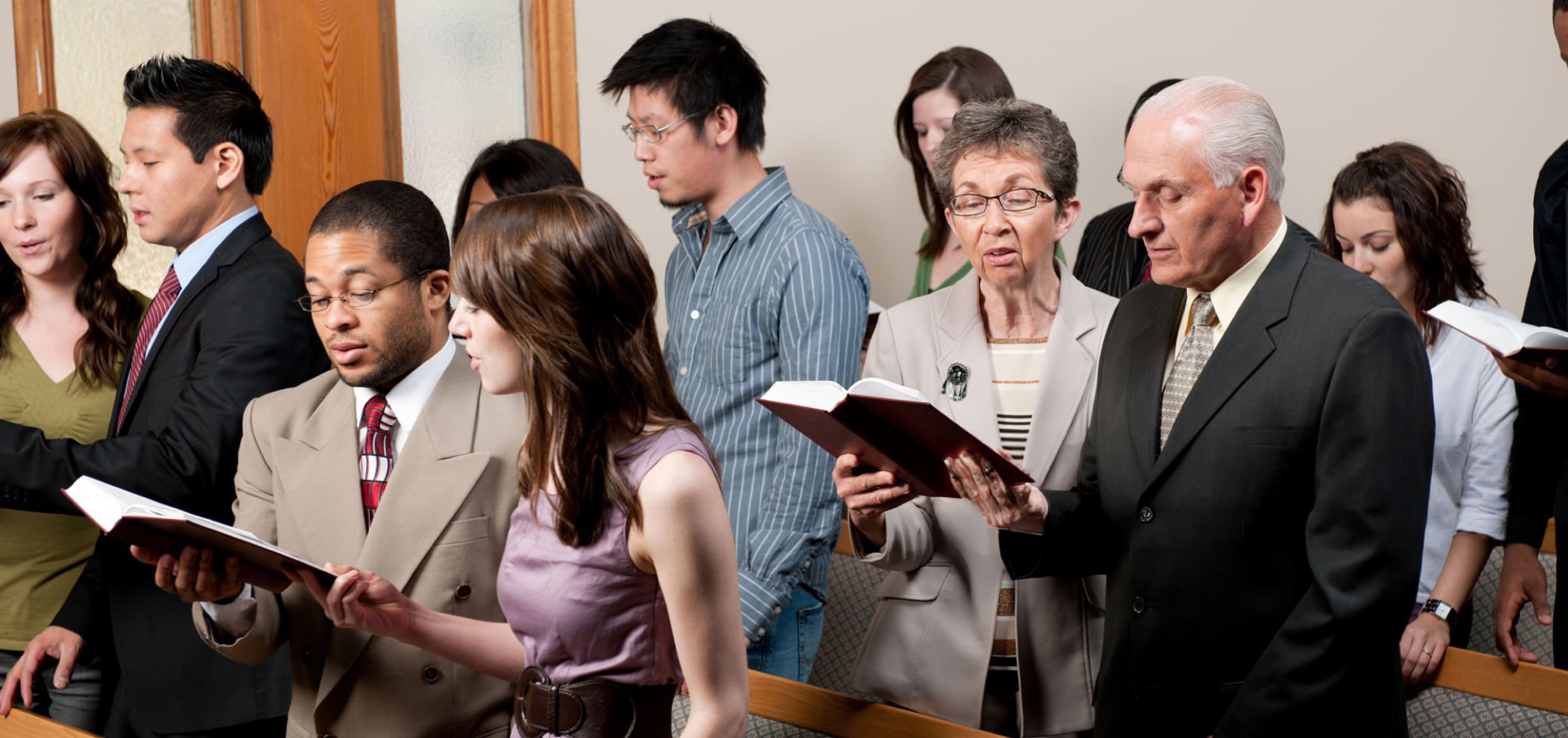 Congregation faithfully worshiping with bibles